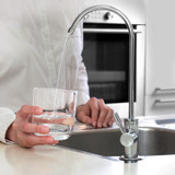 Pouring water from the Brondell RC100 Circle reverse osmosis under counter water filter system