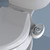 Brondell SouthSpa essential left-handed bidet attachment with dual nozzle installed on toilet in front of a blue background