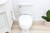 Brondell SouthSpa essential left-handed bidet attachment installed in white bathroom front view.