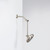 Nebia Adjustable Shower Arm Spot Resist Nickel with a showerhead installed in a downward position with a white background