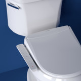 T22 bidet toilet seat installed on the toilet in front of a blue background