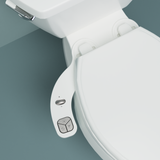Main image of FreshSpa Thinline Precision Essential Bidet Attachment with teal background.